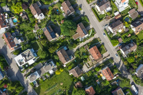 Bright aerial view of a suburban neighbourhood showing houses, backyards and secondary structures on individual erven