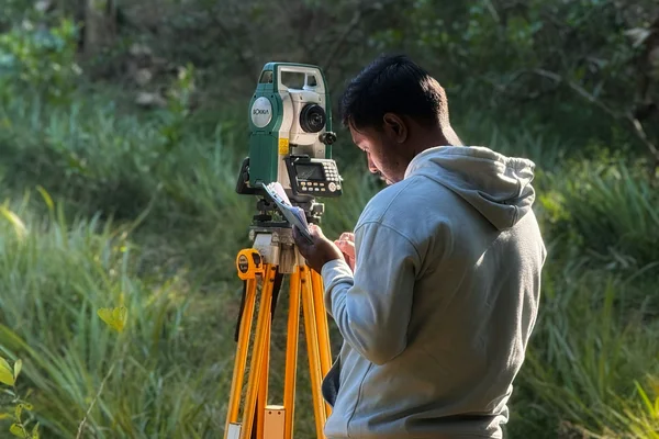 Land surveyor using a total station, zoning certificate and SG diagram guide 2026